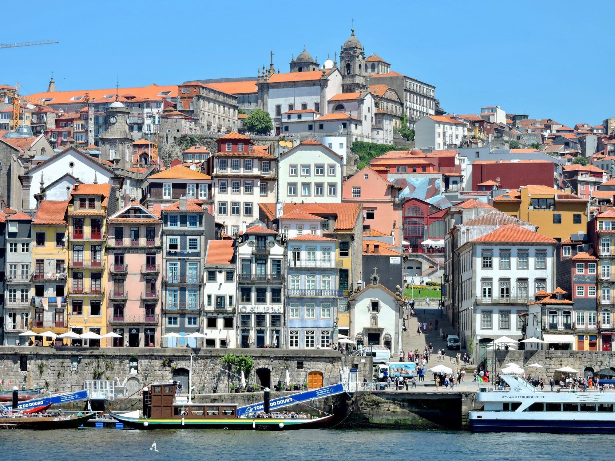 A vibrant view of the historic Ribeira District along the Douro River in Porto, Portugal
